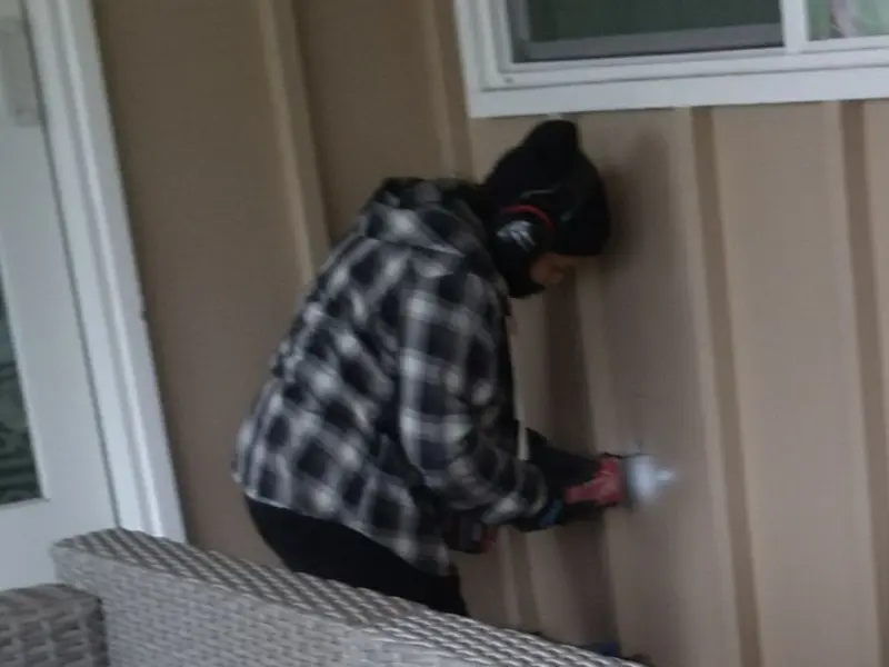 Professional electrician installing an exterior outlet in Tuskegee